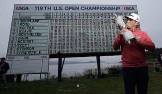FILE - In this June 16, 2019, file photo, Gary Woodland poses with the trophy after winning the U.S. Open Championship golf tournament in Pebble Beach, Calif. Due to the coronavirus pandemic, the golf to watch on Father&#39;s Day this year will not be the U.S. Open as is usually the case. (AP Photo/David J. Phillip, File)