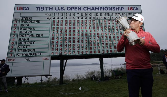 FILE - In this June 16, 2019, file photo, Gary Woodland poses with the trophy after winning the U.S. Open Championship golf tournament in Pebble Beach, Calif. Due to the coronavirus pandemic, the golf to watch on Father&#x27;s Day this year will not be the U.S. Open as is usually the case. (AP Photo/David J. Phillip, File)