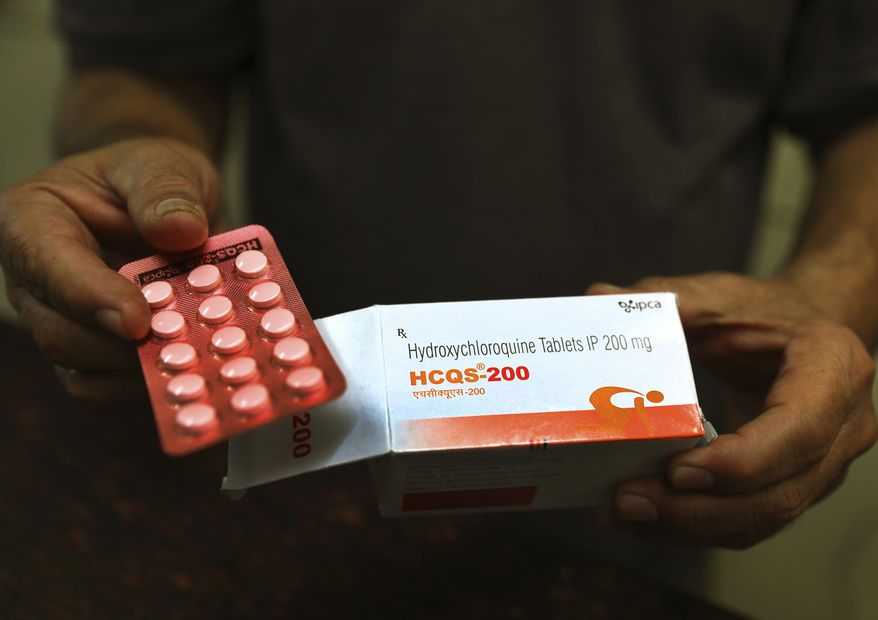 In this April 9, 2020, photo, a chemist displays hydroxychloroquine tablets in New Delhi, India. A new peer-reviewed study suggests the drug may help in treating hospitalized COVID-19 patients. (AP Photo/Manish Swarup) **FILE**