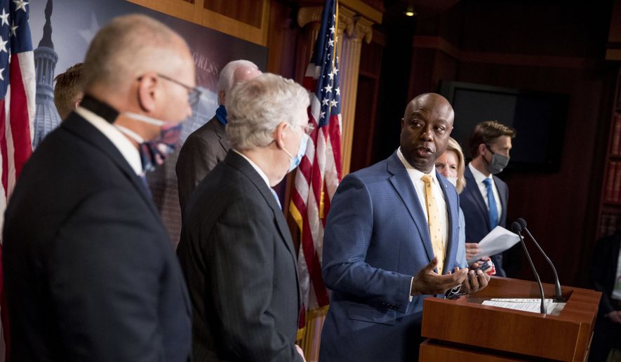 Sen. Tim Scott, R-S.C., accompanied by Senate Majority Leader Mitch McConnell of Ky., second from left, and others, speaks at a news conference to announce a Republican police reform bill on Capitol Hill, Wednesday, June 17, 2020, in Washington. (AP Photo/Andrew Harnik)