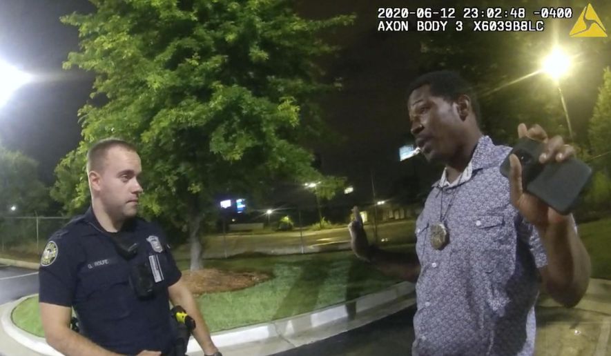 FILE - This screen grab taken from body camera video provided by the Atlanta Police Department shows Rayshard Brooks speaking with Officer Garrett Rolfe, left, in the parking lot of a Wendy&#39;s restaurant, late Friday, June 12, 2020, in Atlanta. Rolfe, who fatally shot Rayshard Brooks in the back after the fleeing man pointed a stun gun in his direction, was charged with felony murder and 10 other charges, announced Wednesday, June 17, 2020. Rolfe was fired after the shooting. (Atlanta Police Department via AP)