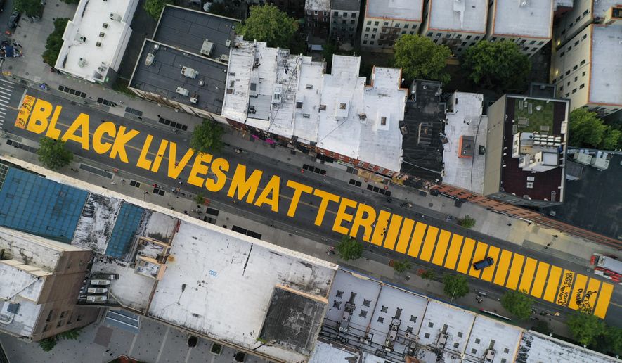 In this  June 15, 2020, file photo, a giant &quot;Black Lives Matter&quot; sign is painted in orange on Fulton Street, Monday, June 15, 2020, in the Brooklyn borough of New York. Black Lives Matter Global Network Foundation, the group behind the emergence of the Black Lives Matter movement, has established a more than $12 million fund to aid organizations fighting institutional racism in the wake of the George Floyd protests. (AP Photo/John Minchillo, File)