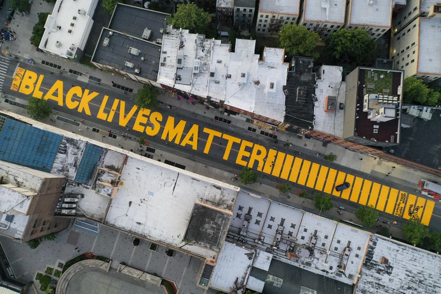 In this June 15, 2020, file photo, a giant "Black Lives Matter" sign is painted in orange on Fulton Street, Monday, June 15, 2020, in the Brooklyn borough of New York. Black Lives Matter Global Network Foundation, the group behind the emergence of the Black Lives Matter movement, has established a more than $12 million fund to aid organizations fighting institutional racism in the wake of the George Floyd protests. (AP Photo/John Minchillo, File)