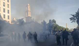 In this June 1, 2020, photo police move demonstrators away from St. John&#39;s Church across Lafayette Park from the White House, as they gather to protest the death of George Floyd in Washington. (AP Photo/Alex Brandon) **FILE**