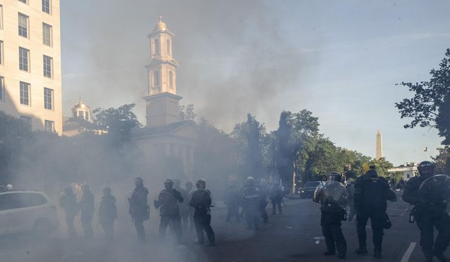 In this June 1, 2020, photo police move demonstrators away from St. John&#x27;s Church across Lafayette Park from the White House, as they gather to protest the death of George Floyd in Washington. (AP Photo/Alex Brandon) **FILE**