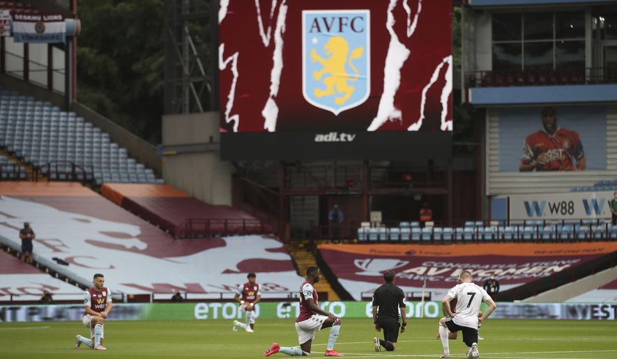 Players kneel prior to the start of the English Premier League soccer match between Aston Villa and Sheffield United at Villa Park in Birmingham, England, Wednesday, June 17, 2020. The English Premier League resumes Wednesday after its three-month suspension because of the coronavirus outbreak. (Carl Recine/Pool via AP)