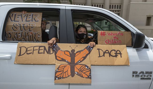 An immigrant family joins members of Coalition for Humane Immigrant Rights of Los Angeles, CHIRLA, on a vehicle caravan rally to support the Deferred Action for Childhood Arrivals Program (DACA), around MacArthur Park in Los Angeles, Thursday, June 18, 2020. (AP Photo/Damian Dovarganes) ** FILE **