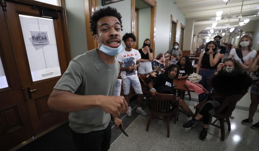 Matthew Bruce, of Des Moines, Iowa, leads a Black Lives Matter demonstration outside Iowa Gov. Kim Reynolds' office, Thursday, June 18, 2020, at the Statehouse in Des Moines, Iowa. (AP Photo/Charlie Neibergall)