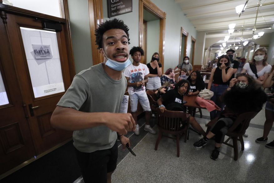 Matthew Bruce, of Des Moines, Iowa, leads a Black Lives Matter demonstration outside Iowa Gov. Kim Reynolds' office, Thursday, June 18, 2020, at the Statehouse in Des Moines, Iowa. (AP Photo/Charlie Neibergall)