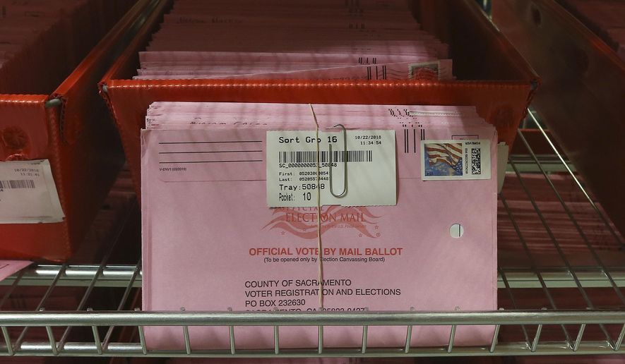 FILE - In this Oct. 22, 2018, file photo, mail-in ballots are placed in bins to be processed after arriving at the Sacramento County Registrar of Voters in Sacramento, Calif. The California Assembly on Thursday, June 18, 2020, sent Gov. Gavin Newsom a bill to require county election officials to mail a ballot to every registered voter in the state, which would cement into law the Democratic governor's earlier order to mail out ballots statewide in response to the coronavirus outbreak. Newsom, citing health risks, announced in early May that the state will send every voter a mail-in ballot for the November contest, but that order has been challenged in court. (AP Photo/Rich Pedroncelli, File)