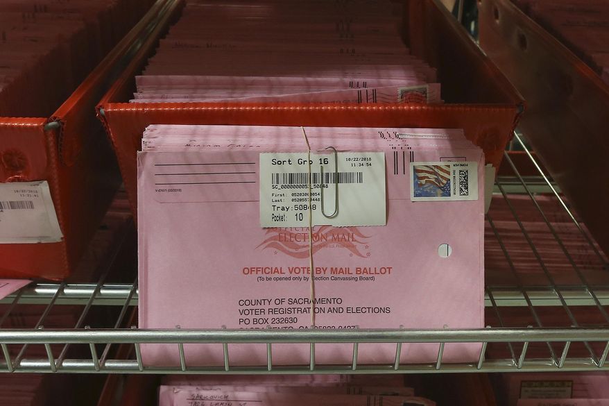 FILE - In this Oct. 22, 2018, file photo, mail-in ballots are placed in bins to be processed after arriving at the Sacramento County Registrar of Voters in Sacramento, Calif. The California Assembly on Thursday, June 18, 2020, sent Gov. Gavin Newsom a bill to require county election officials to mail a ballot to every registered voter in the state, which would cement into law the Democratic governor's earlier order to mail out ballots statewide in response to the coronavirus outbreak. Newsom, citing health risks, announced in early May that the state will send every voter a mail-in ballot for the November contest, but that order has been challenged in court. (AP Photo/Rich Pedroncelli, File)