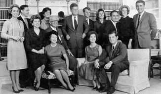 FILE - In this December, 1960, file photo, then President-elect John F. Kennedy, standing at center, is surrounded by members of his family in home of his parents in Hyannis Port, Mass. Standing, left to right, are Ethel Kennedy, wife of Robert Kennedy; Steven Smith and wife Jean Kennedy Smith; Robert Kennedy; Patricia Kennedy Lawford; Sargent Shriver, Joan Kennedy, wife of Edward Kennedy; and Peter Lawford. Foreground, left to right: Eunice Kennedy Shriver, Joseph P. Kennedy and wife Rose Kennedy seated in front; Jacqueline Kennedy; and Edward Kennedy. The death on Wednesday, June 17, 2020, of Jean Kennedy Smith, the last surviving sibling of President Kennedy, means Camelot&#39;s inner circle is almost gone. (AP Photo, File)