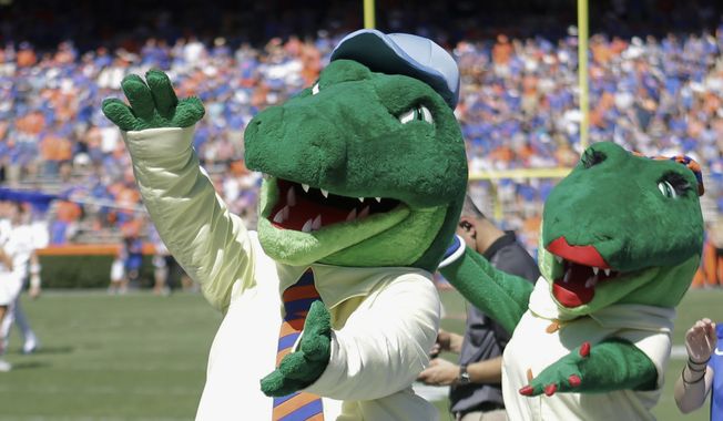 In this Nov. 7, 2015, file photo, Albert and Alberta, the mascots for Florida, do the gator chomp before the first half of an NCAA college football game against Vanderbilt in Gainesville, Fla. The University of Florida is ending its &quot;gator bait&quot; cheer at football games and other sports events because of its racial connotations, the school&#x27;s president announced Thursday, June 18, 2020, in a letter making several other similar changes on campus. (AP Photo/John Raoux, File)