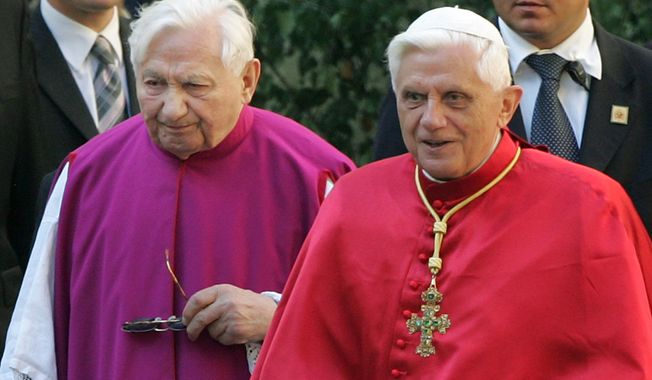 FILE - In this Sept. 13, 2006 file picture Pope Benedict XVI, right, walks with his brother priest Georg Ratzinger in Regensburg, southern Germany. The Vatican says Emeritus Pope Benedict is in Germany to be with his brother, who is in poor health. Benedict on Thursday arrived in Regensburg, Germany, where his brother, the Rev. Georg Ratzinger, lives, and where “he will spend the necessary time,” the Vatican said in a statement. (AP Photo/Diether Endlicher,File)