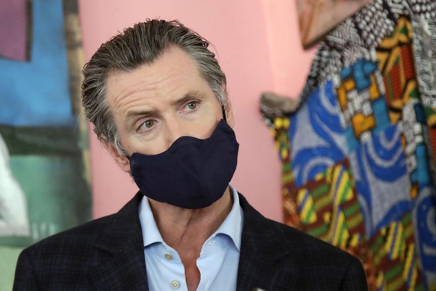In this June 9, 2020, file photo, California Gov. Gavin Newsom wears a protective mask on his face while speaking to reporters at Miss Ollie's restaurant during the coronavirus outbreak in Oakland, Calif. Gov. Newsom's administration on Thursday, June 18, 2020, mandated that Californians wear masks in most indoor settings as the state continues to battle the coronavirus.(AP Photo/Jeff Chiu, Pool, File)