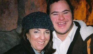 In this photo provided by Yaelle Ehrenpreis Meyer, Ahava Ehrenpreis and her son, Saadya Ehrenpreis, pose for a picture in the Brooklyn borough of New York. Saadya Ehrenpreis was hospitalized with COVID-19 in April and died a month before he would have graduated from the Makor College Experience program at Yeshiva University. (Yaelle Ehrenpreis Meyer via AP)