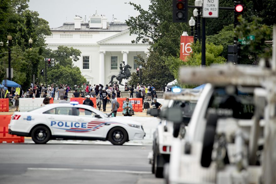 The White House is visible at 16th Street Northwest renamed Black Lives Matter Plaza, Friday, June 19, 2020, in Washington. (AP Photo/Andrew Harnik)