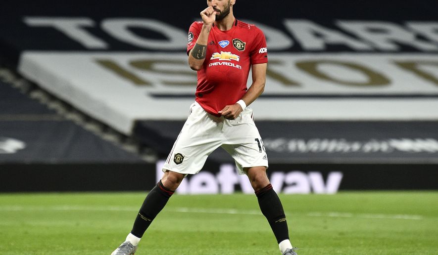 Manchester United's Bruno Fernandes reacts after kicking a penalty to level the scores during the English Premier League soccer match between Tottenham Hotspur and Manchester United at Tottenham Hotspur Stadium in London, England, Friday, June 19, 2020. (AP Photo/Glyn Kirk, Pool)