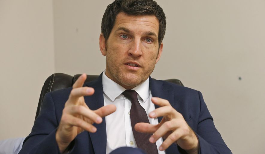 FILE This Friday, Oct. 7, 2016, photo, Virginia's 2nd District Congressman Scott Taylor speaks during an interview in his campaign office in Virginia Beach, Va. Taylor, a former sniper in Iraq, is running in the Virginia 2nd Congressional District GOP primary against Ben Loyola Jr. and Jarome Bell. Taylor, a former Navy Seal, narrowly lost to U.S. Rep. Elaine Luria in 2018 in one of the most competitive congressional district in the country. (AP Photo/Steve Helber)