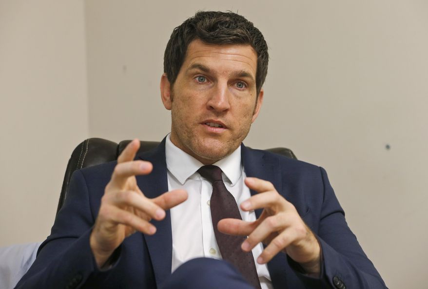 FILE This Friday, Oct. 7, 2016, photo, Virginia's 2nd District Congressman Scott Taylor speaks during an interview in his campaign office in Virginia Beach, Va. Taylor, a former sniper in Iraq, is running in the Virginia 2nd Congressional District GOP primary against Ben Loyola Jr. and Jarome Bell. Taylor, a former Navy Seal, narrowly lost to U.S. Rep. Elaine Luria in 2018 in one of the most competitive congressional district in the country. (AP Photo/Steve Helber)