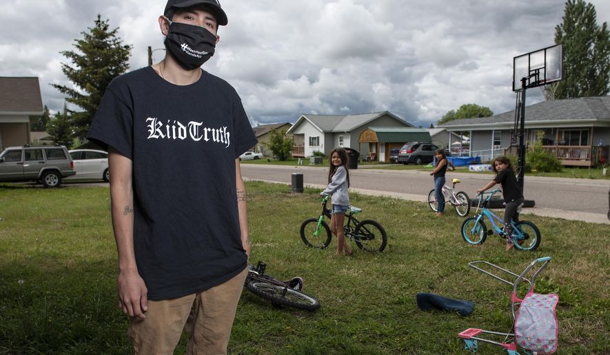 In this photo taken June 16, 2020, Artie Mendoza III, 25, also known as KiidTruth, looks on outside his home in Pablo, Montana. Mendoza created a viral TIk Tok dance and song to promote hand washing, mask wearing and social distancing among the youth on the Flathead Indian Reservation. Mendoza's children inspired him to create the dance. "And so I put two and two together, I am aiming for our youth, why not make a fun dance too." he said. (AP Photo/Tommy Martino)