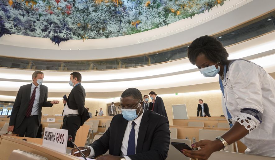 Delegates are seen prior to the vote at the United Nations Human Rights Council in Geneva, Switzerland, Friday, June 19, 2020. The U.N.’s top human rights body has voted unanimously to commission a U.N. report on systemic racism and discrimination against blacks. (Fabrice Coffrini/Pool Photo via AP)