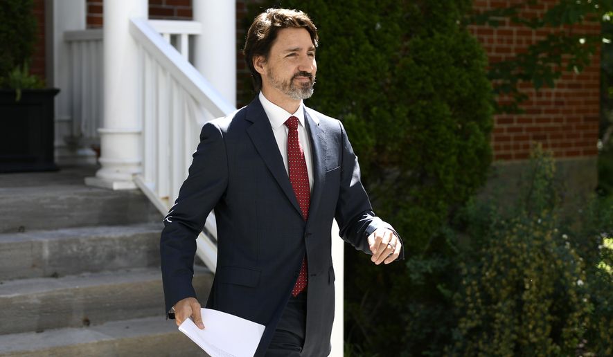 Prime Minister Justin Trudeau arrives for a news conference on the COVID-19 pandemic outside his residence at Rideau Cottage in Ottawa, Thursday, June 18, 2020. (Justin Tang/The Canadian Press via AP)