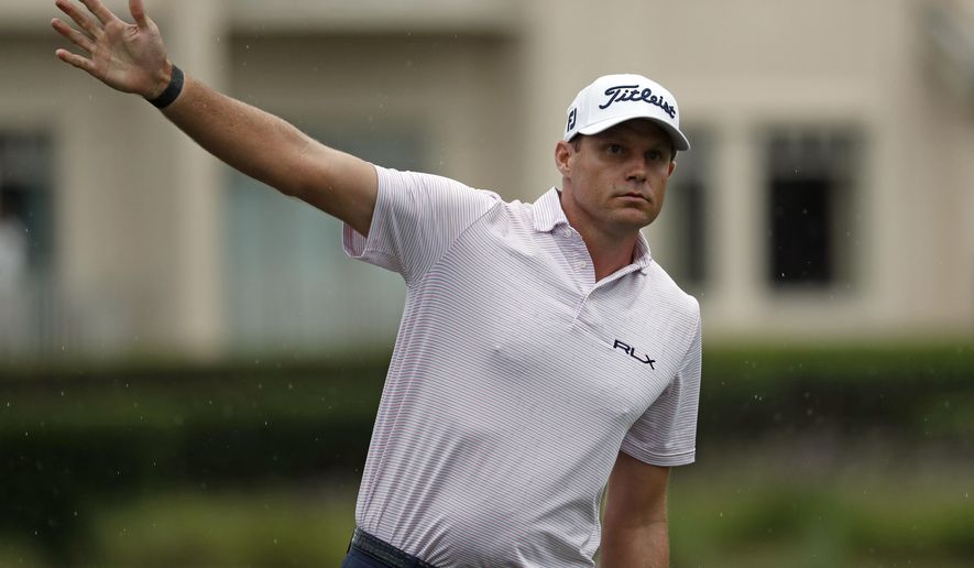 In this photo taken Thursday, June 18, 2020 Nick Watney signals after a tee shot during the first round of the RBC Heritage Golf tournament at Harbour Town Golf Links in Hilton Head, S.C. Watney has tested positive for coronavirus and did not play in Friday's round. (AP Photo/Gerry Broome)