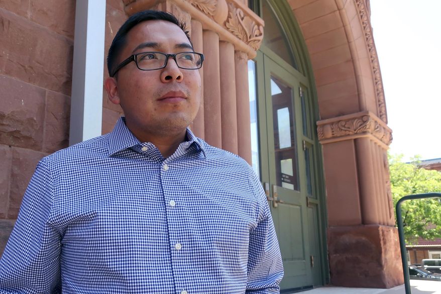 FILE - In this June 28, 2019, file photo, Tremayne Nez stands outside the Coconino County courthouse in Flagstaff, Ariz. The Flagstaff man who was wrongfully arrested on suspicion of selling LSD has sued the city, alleging police ignored evidence that showed he wasn't a drug dealer. Nez, who is Navajo, spent more than 30 hours in jail after being arrested last June as part of a multi-agency drug operation. Police have said his arrest was a case of mistaken identity. (AP Photo/Felicia Fonseca, File)