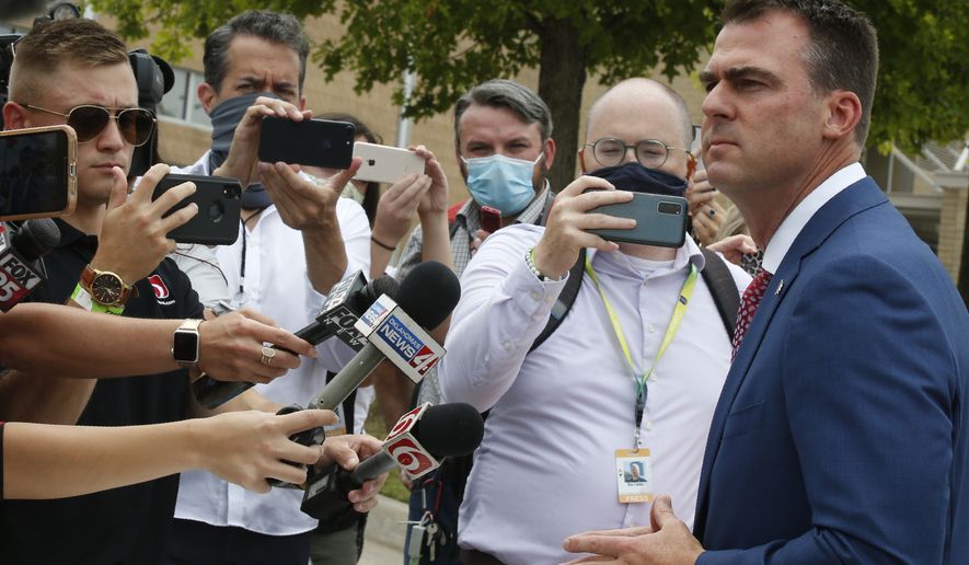Oklahoma Gov. Kevin Stitt stops to talk to the media outside the BOK Center where President Trump will hold a rally in Tulsa, Okla., Saturday, June 20, 2020. (AP Photo/Sue Ogrocki)