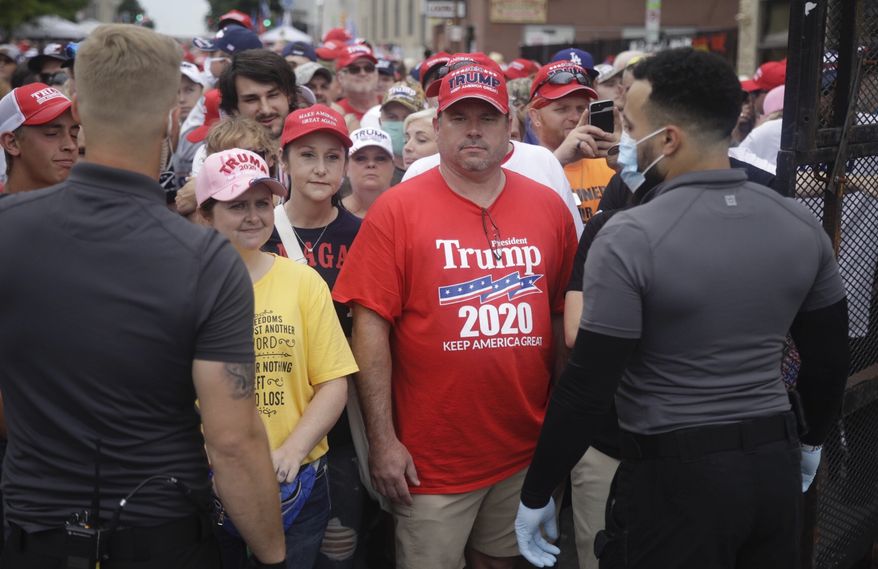 Safety barricade gates are opened for supporters to enter for President Donald Trump's campaign rally Saturday, June 20, 2020 in Tulsa, Okla. (Mike Simons/Tulsa World via AP)