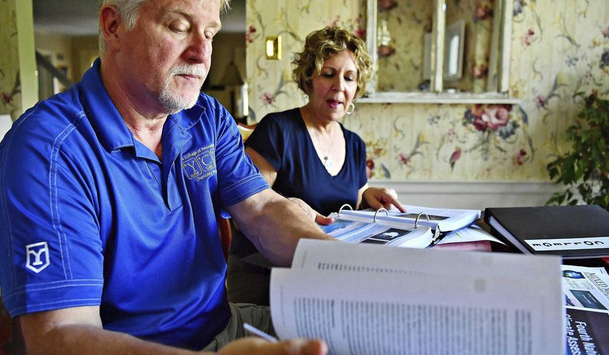 In this June 20, 2019, photo, Dr. Greg Foy, left, and his wife Leigh Foy discuss their upcoming climate change workshop during an interview at their home in Spring Garden Township, Pa. (Dawn J. Sagert/York Dispatch via AP)