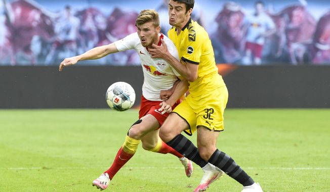 Leipzig&#x27;s Timo Werner, left, and Dortmund&#x27;s Giovanni Reyna fight for the ball during the German Bundesliga soccer match between RB Leipzig and Borussia Dortmund in Leipzig, Germany, Saturday, June 20, 2020. (AP Photo/Jens Meyer, Pool)