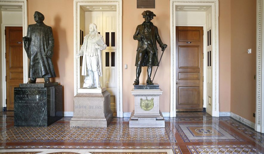 FILE - In this March 28, 2011, file photo, a larger-than-life bronze statue of Patrick A. McCarran of Nevada, left, stands near the entrance to the Senate floor on Capitol Hill in Washington. Democratic members of Nevada's congressional delegation are renewing a proposal to remove a statute of a former Nevada Sen. McCarran from the U.S. Capitol’s Statuary Hall, saying that he left a “legacy of racism, anti-Semitism, and xenophobia.” (AP Photo/J. Scott Applewhite, File)
