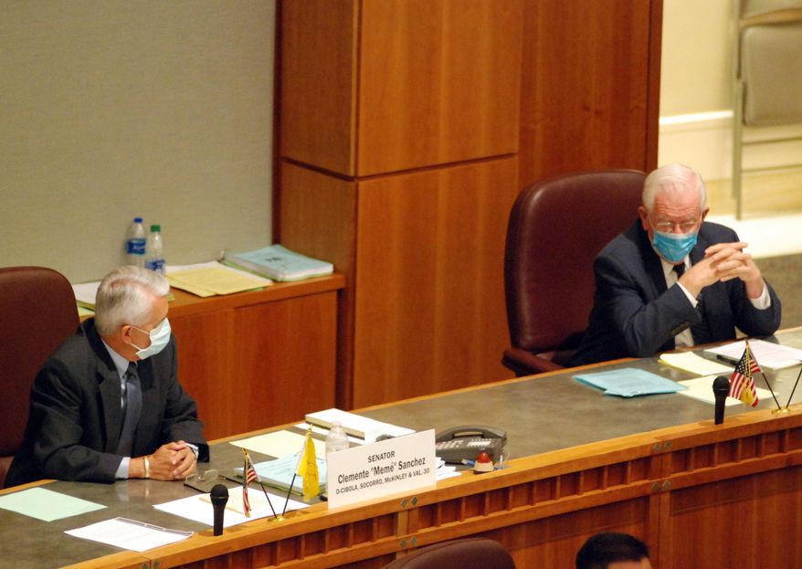 Democratic Sensators Clemente Sanchez of Grants, left, and John Arthur Smith, of Deming, listen to a tribute from colleagues during a special session Saturday, June 20, 2020. The session may be their last after losing in the June 2 primary to more progressive contenders. The New Mexico Legislature met in a special session to address a gaping budget hole linked to the coronavirus and economic upheaval. (AP Photo/Morgan Lee)