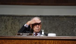 Chairman Chuck Grassley, R-Iowa, covers his eyes as he listens to U.S. Trade Representative Robert Lighthizer speak during a Senate Finance Committee hearing on U.S. trade on Capitol Hill, Wednesday, June 17, 2020, in Washington. (Anna Moneymaker/The New York Times via AP, Pool)
