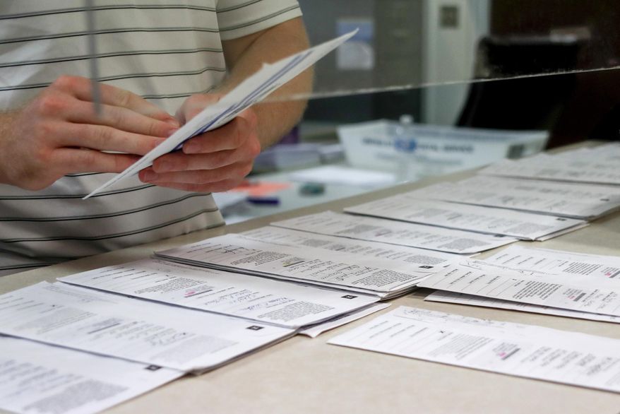 In this May 28, 2020, photo, processing work on mail-in ballots for the Pennsylvania Primary election is being done by Tim Vernick at the Butler County Bureau of Elections, in Butler, Pa. The civic ritual of casting a ballot has been disrupted by a global pandemic and dramatically animated by social unrest. And If the results of a frustrating, chaotic primary in Georgia are a measure, the notion of democracy itself will also be on the ballot in the November election. Congress is now considering sending $3.6 billion to states to help facilitate safe and fair elections as part of another round of relief funds to recover from the coronavirus pandemic. (AP Photo/Keith Srakocic) **FILE**