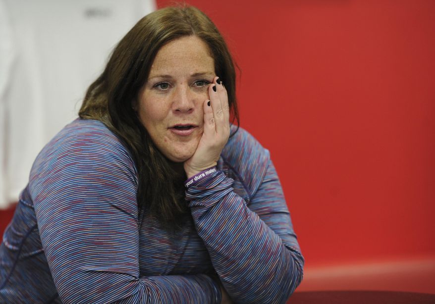 Colleen Tyrrell Llacsa prepares to work out at the UFC gym in Naperville with trainer Matthew Kuschert on May 13, 2020. Llacsa is working her way back from a terrible medical incident that left her suffering from cerebral spinal fluid leak causing numbness, weakness and double vision. (Mark Welsh/Daily Herald, via AP)