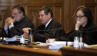 In this March 26, 2009 file photo, Connecticut state Supreme Court Justice Richard Palmer, center, questions attorneys at the Connecticut Supreme Court in Hartford, Conn. Palmer, who authored the landmark Connecticut Supreme Court rulings that legalized same-sex marriage and abolished the state&#39;s death penalty, is stepping down after 27 years on the high court. He reached the state&#39;s mandatory retirement age of 70 for judges late last month, but will continue to work on cases he heard before then. (AP Photo/Bob Child, Pool)