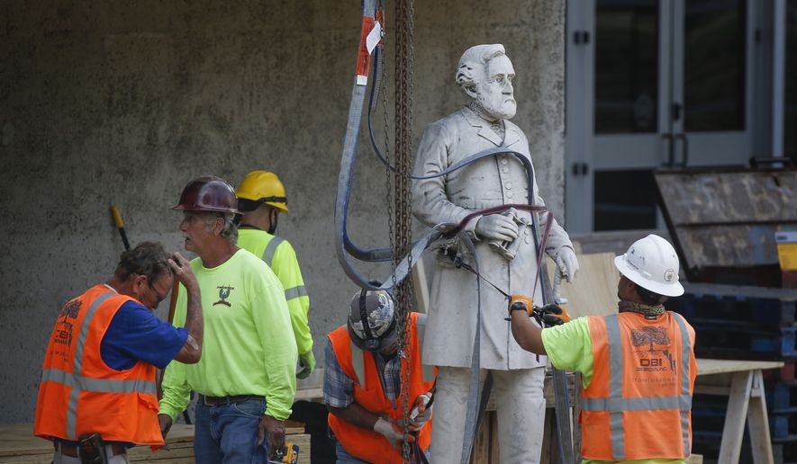 Construction workers move a statue of Confederate Gen. Robert E. Lee as they begin the removal of the Confederate War Memorial at Pioneer Park on Monday, June 22, 2020, in downtown Dallas. (Ryan Michalesko/The Dallas Morning News via AP)