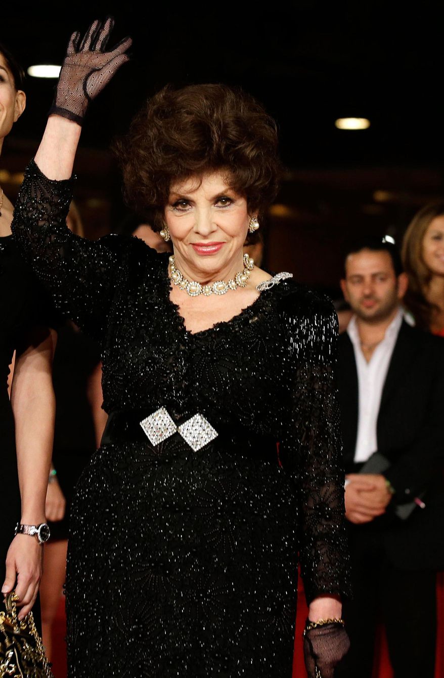 In this Nov. 16, 2012 file photo, actress Gina Lollobrigida poses for photographers as she arrives for the screening of a documentary on Miss Italy during the 7th edition of the Rome International Film Festival in Rome. (AP Photo/Gregorio Borgia, File)