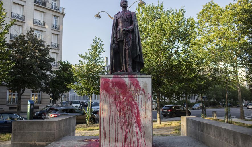 The statue of Hubert Lyautey, who served in Morocco, Algeria, Madagascar and Indochina when they were under French control, is offered with red painting Monday, June 22, 2020. Two statues related to France's colonial era were covered in graffiti Monday amid a global movement to take down monuments to figures tied to slavery or colonialism. (AP Photo/Rafael Yaghobzadeh)