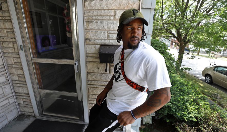 Daylan McLee sits on the porch of his home in Uniontown, Pa., Monday, June 22, 2020. On Sunday McLee helped pull Uniontown Police Officer Jay Hanley from his burning patrol car following a collision. (AP Photo/Gene J. Puskar)