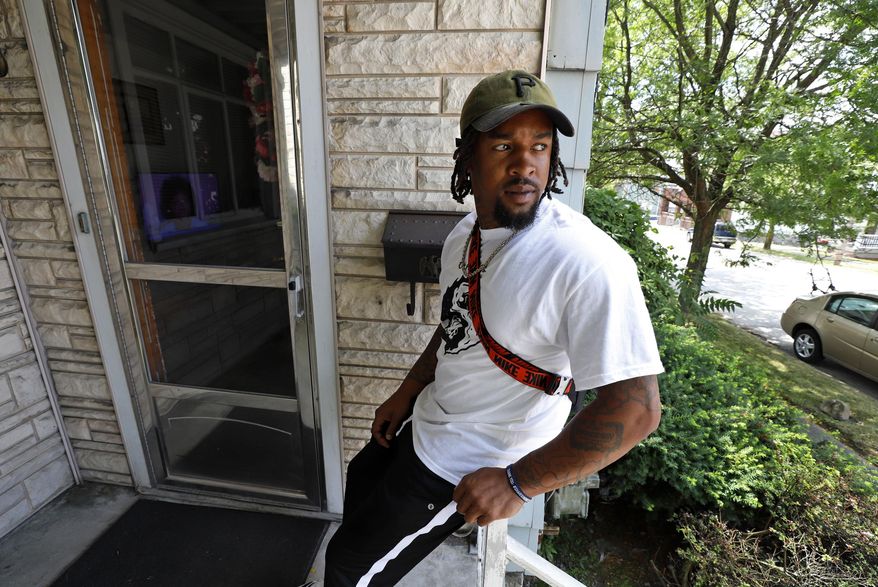 Daylan McLee sits on the porch of his home in Uniontown, Pa., Monday, June 22, 2020. On Sunday McLee helped pull Uniontown Police Officer Jay Hanley from his burning patrol car following a collision. (AP Photo/Gene J. Puskar)