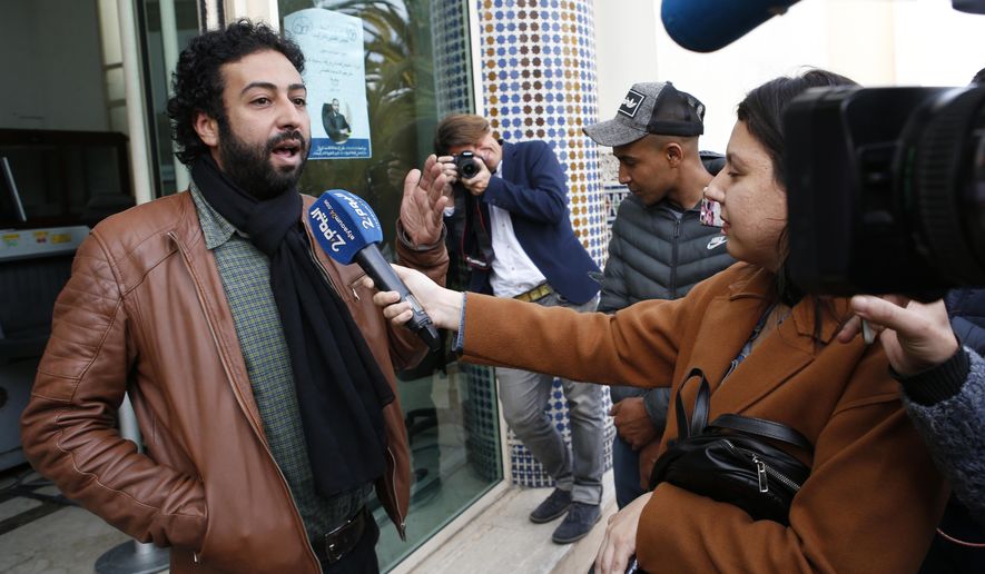 FILE - In this March 5, 2020 file photo, journalist and activist Omar Radi speaks to the media after his hearing at the Casablanca Courthouse, In Casablanca, Morocco. Amnesty International says sophisticated telephone surveillance software appears to have been used to spy on journalist-activist Omar Radi in Morocco, in a continuing crackdown on dissent in the North African kingdom. (AP Photo/Abdeljalil Bounhar, File)