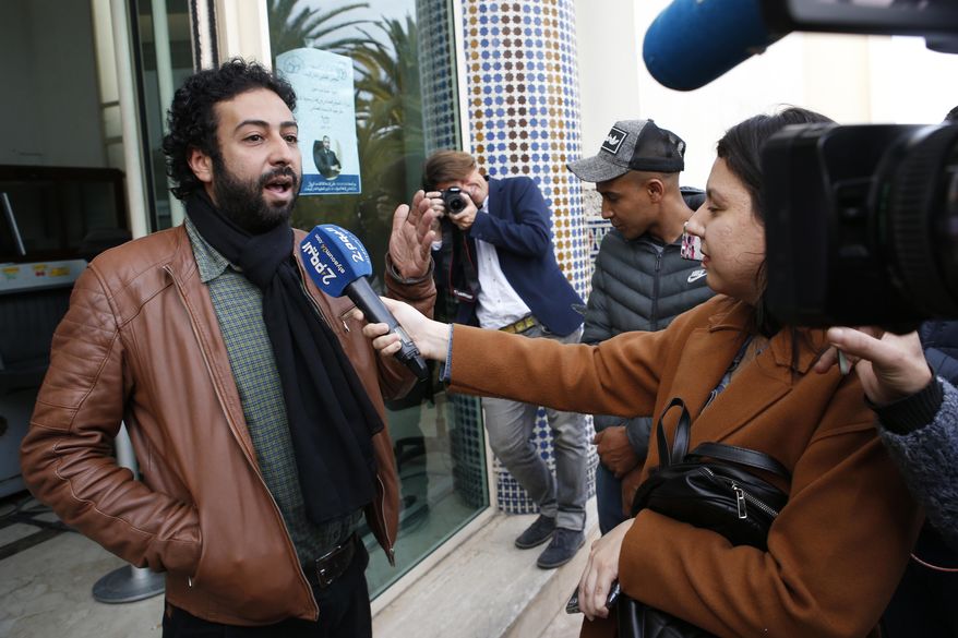 FILE - In this March 5, 2020 file photo, journalist and activist Omar Radi speaks to the media after his hearing at the Casablanca Courthouse, In Casablanca, Morocco. Amnesty International says sophisticated telephone surveillance software appears to have been used to spy on journalist-activist Omar Radi in Morocco, in a continuing crackdown on dissent in the North African kingdom. (AP Photo/Abdeljalil Bounhar, File)