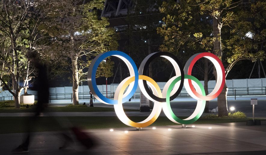 FILE - In this March 30, 2020, file photo, the Olympic rings are displayed in Tokyo. Elk Grove Village has a rose. A nice green one with five zeroes behind it. Now it is looking for the right partner. With Olympic leaders concerned about funding heading into the Tokyo Games, Elk Grove is looking to sponsor a U.S. federation in another bid to generate exposure for the Chicago suburb after it attracted some lucrative attention for its partnership with college football's Bahamas Bowl. (AP Photo/Jae C. Hong, File)