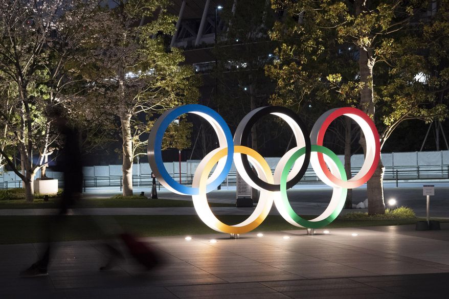 FILE - In this March 30, 2020, file photo, the Olympic rings are displayed in Tokyo. Elk Grove Village has a rose. A nice green one with five zeroes behind it. Now it is looking for the right partner. With Olympic leaders concerned about funding heading into the Tokyo Games, Elk Grove is looking to sponsor a U.S. federation in another bid to generate exposure for the Chicago suburb after it attracted some lucrative attention for its partnership with college football's Bahamas Bowl. (AP Photo/Jae C. Hong, File)