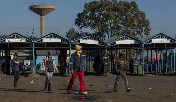 Stranded commuters walks away from a deserted taxi rank in Katlehong, South Africa, Monday, June 22, 2020, as taxi drivers affiliated to the SA National Taxi Council (Santaco) protested against what it believes to be insufficient government relief offered to the industry. South Africa&#x27;s largest city, Johannesburg, has been hit by a strike by mini-bus taxis, preventing many thousands of people from getting to work on Monday, as the country reopens its economy even as cases of COVID-19 are increasing. (AP Photo/Themba Hadebe)