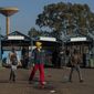 Stranded commuters walks away from a deserted taxi rank in Katlehong, South Africa, Monday, June 22, 2020, as taxi drivers affiliated to the SA National Taxi Council (Santaco) protested against what it believes to be insufficient government relief offered to the industry. South Africa&#39;s largest city, Johannesburg, has been hit by a strike by mini-bus taxis, preventing many thousands of people from getting to work on Monday, as the country reopens its economy even as cases of COVID-19 are increasing. (AP Photo/Themba Hadebe)